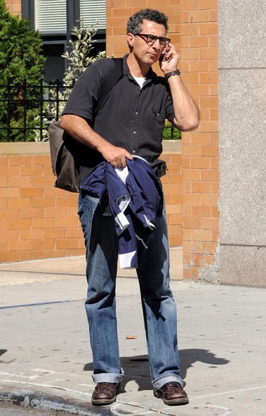 john turturro John cuffing jeans on phone