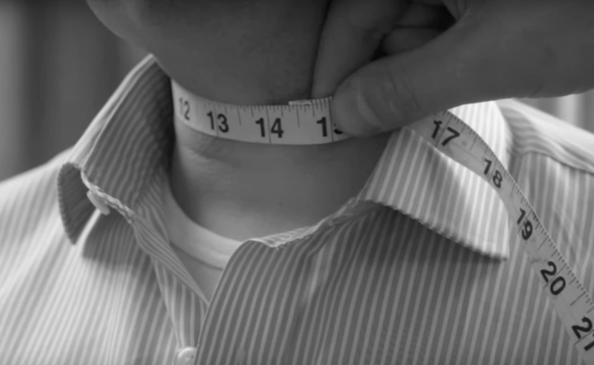 DeoVeritas logo with a professional businessman in a pinstripe suit at a corporate meeting or seminar setting.