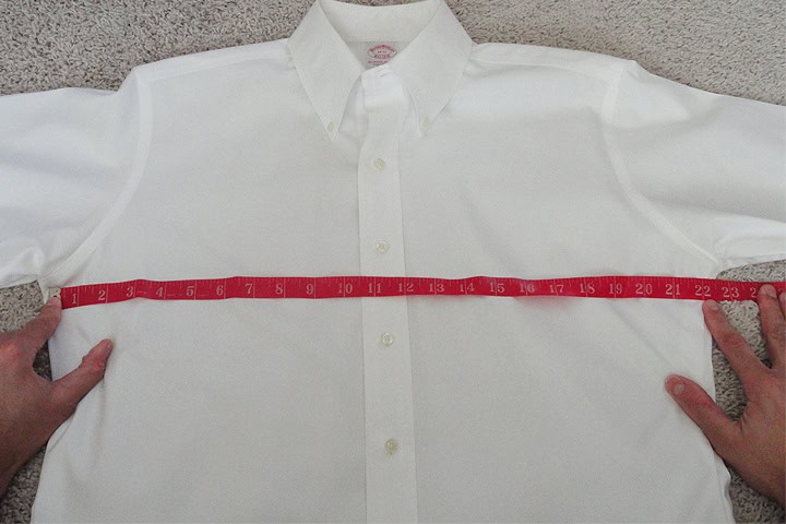 DeoVeritas logo with a professional businessman in a pinstripe suit at a corporate meeting or seminar setting.