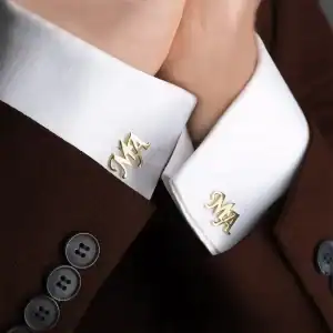 Elegant men's brown suit with white dress shirt and personalized gold cufflinks featuring monogram initials MY, perfect for formal occasions and business attire.