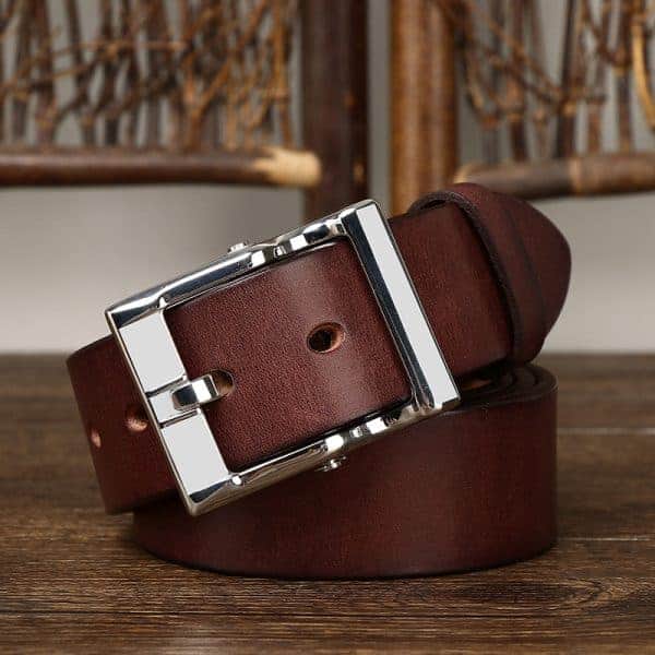 Luxury brown leather belt with a polished metal buckle, perfect for stylish men and women. Made of high-quality material, ideal for casual or formal wear, offering durability and timeless fashion.