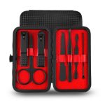 Instrument grooming kit with nail scissors, tweezers, and scissors in a black and red travel case.