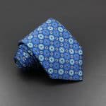 Elegant blue patterned men's tie featuring intricate geometric designs, perfect for formal occasions and enhancing professional attire.