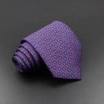 Vivid men's patterned silk tie with geometric design, perfect for formalwear and business attire, showcasing high-quality craftsmanship and stylish accessories for men.