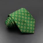Bright green patterned men’s dress tie with a geometric floral design, ideal for formal occasions and adding a touch of elegance to your outfit. Perfect for business, events, or stylish everyday wear.