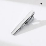 Shiny silver tie clip on a white background, stylish men's accessory, high-quality metal finish, perfect for formal wear, Deoveritas branding.