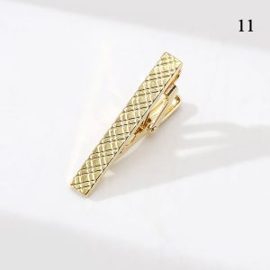 Gold textured tie clip with geometric pattern for men's formal accessories.