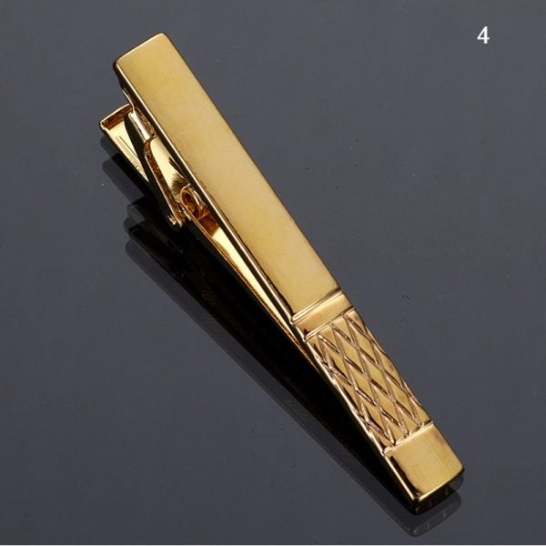 Gold-tone tie clip with textured handle and polished finish for men's accessories and professional style.