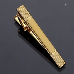 Luxury gold tie clip with textured detail, perfect for formal occasions and adding elegance to business attire.