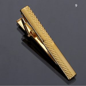 Gold tie clip with textured pattern for men's accessories and style enhancement.