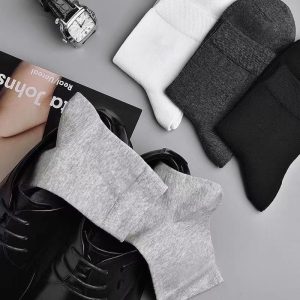 Plain grey socks with black dress shoes, men's formal attire essentials.