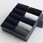 Black and gray men's dress socks organized in a sleek black box, perfect for gifting or personal use, showcasing premium quality and stylish comfort.