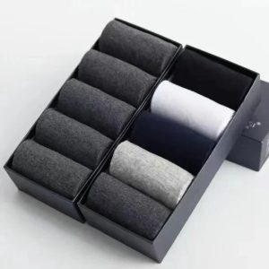 Dark gray, black, and white men's dress socks neatly organized in a stylish black gift box. Perfect for gifting or personal use, showcasing quality and sophistication.