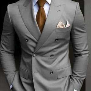 Elegant man in a tailored gray suit with a brown tie and pocket square, showcasing sophisticated men's fashion and business attire.