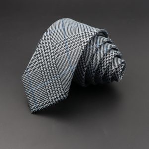 Polished black and white plaid men’s tie on dark grey background, stylish accessory for business and formal occasions, premium quality, classic pattern, versatile and elegant.