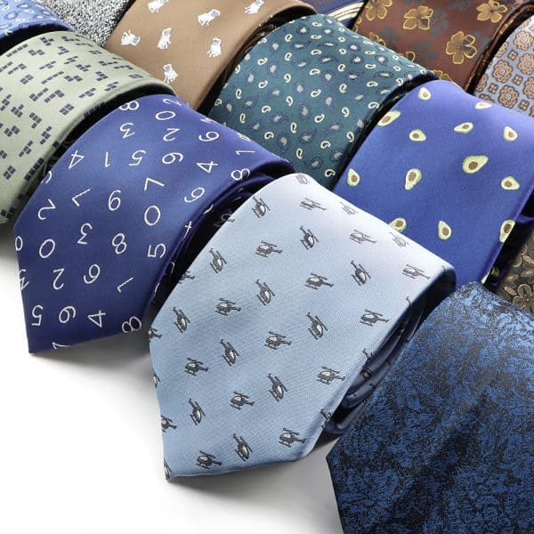 Soft silk neckties featuring various patterns such as numbers, logos, and geometric designs, ideal for men's fashionable accessories and professional attire.