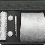 Elegant men's grooming set in silver floral design with tie, cufflinks, tie clip, and wallet in a black gift box, perfect for sophisticated occasions.