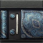 Elegant men's accessory gift set featuring a paisley silk tie, matching cufflinks, tie clip, and pocket square in blue tones for sophisticated style.