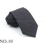 Dark gray men's dress tie with subtle pinstripes, neatly rolled up on a white background, ideal for formal occasions and professional attire at DeoVeritas.