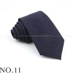 Elegant navy men's necktie with subtle checkered pattern, perfect for professional and formal occasions. Crafted from high-quality fabric, offering a stylish and sophisticated look.