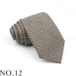 Classic houndstooth patterned men's necktie in beige, black, and white, ideal for formal occasions and professional attire. Perfect accessory for a stylish, sophisticated look.