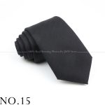 Fine black men's necktie with subtle diagonal pattern, suitable for formal and business attire. Perfect accessory for professional occasions, weddings, and elegant events. High-quality fabric for a polished look.