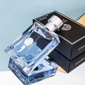 Elegant clear glass perfume bottle with silver cap and black box packaging for luxury fragrances.