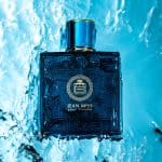 Fresh Jean Miss Pour Homme cologne bottle submerged in water with vibrant blue background, showcasing a luxury men's fragrance product for an elegant and refreshing appeal.