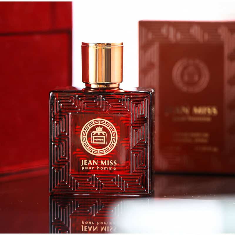 Red Jean Miss Pour Homme perfume bottle with gold cap, luxury packaging, and intricate design details.