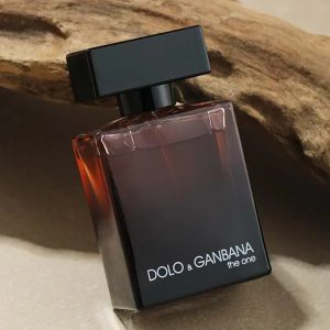 Dolo & Gabbana perfume bottle with sleek black and red design, positioned on natural wooden surface for luxury fragrance display.