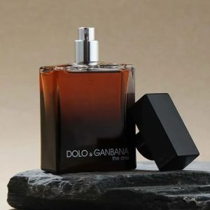 Dolo & Ganjana the one perfume bottle with black cap on a textured surface, showcasing a classic fragrance design.
