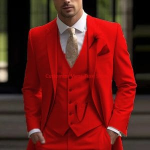 Elegant red men's suit with a tailored blazer, vest, and accessories, showcasing sophisticated formal fashion for special occasions or business events.