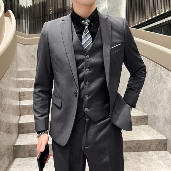 Sharp tailored men's suit with black dress shirt, striped tie, and matching vest, perfect for formal events and business occasions. Elegant, modern, stylish, and professional attire for men.