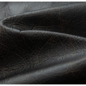 Soft black leather texture with natural grain patterns, high-quality material ideal for luxury fashion accessories and upholstery.