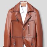 Premium brown leather men's trench coat with stylish design, zipper pocket, and button details for sophisticated fall and winter fashion.
