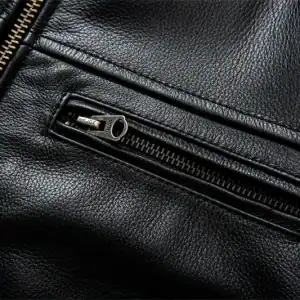Smooth black leather jacket with a close-up of a metal zipper pocket, showcasing high-quality craftsmanship and stylish design.