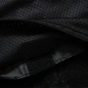 Sturdy black backpack interior with zipper closure, padded compartments, and secure Velcro strap for organization and safety. Ideal for daily use, travel, or outdoor activities.