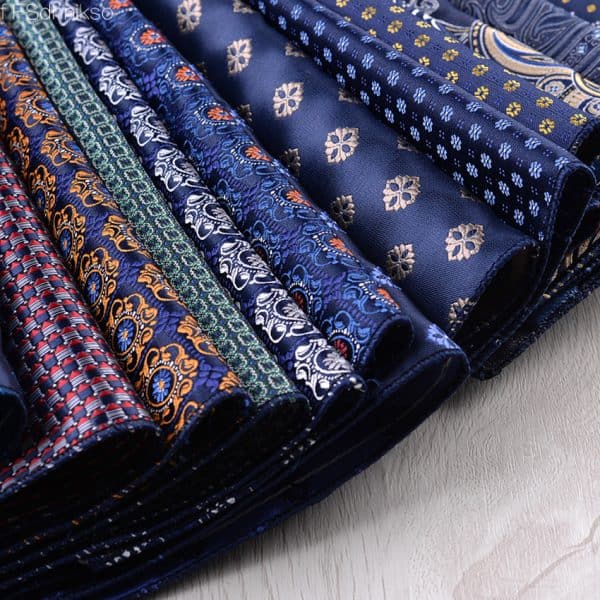Vibrant blue and patterned silk ties featuring intricate floral and geometric designs, perfect for formal or business attire, showcasing high-quality craftsmanship and elegant style.