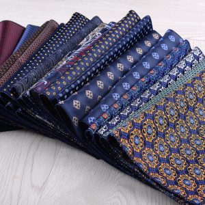 Elegant men's tie collection featuring various shades of blue with intricate patterns, perfect for formal wear and stylish occasions.