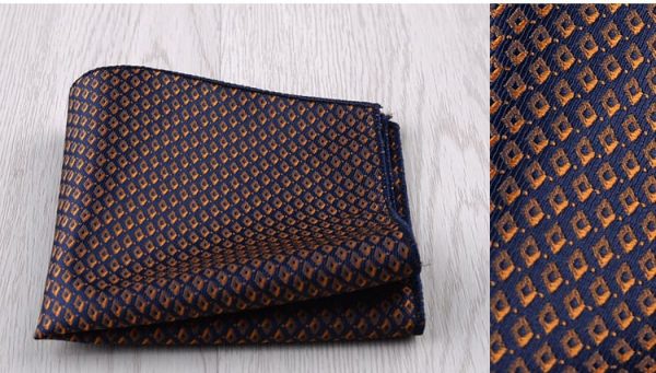 Luxurious dark blue and gold patterned silk pocket square with intricate geometric design, perfect for adding elegance to formal attire.
