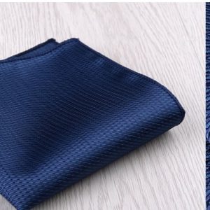 Dark blue textured fabric neatly folded, suitable for clothing or upholstery applications.