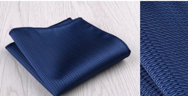 Dark blue textured fabric neatly folded, suitable for clothing or upholstery applications.