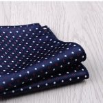 Luxurious navy blue silk pocket square with white and red geometric polka dot pattern, perfect for elegant men's fashion accessories.
