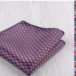 Vivid patterned patterned pocket square featuring red, navy blue, and white geometric designs, perfect for formal or casual occasions.