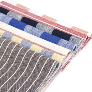 Vivid collection of colorful striped and checkered linen napkins showcasing high-quality textile fabric for elegant table setting.