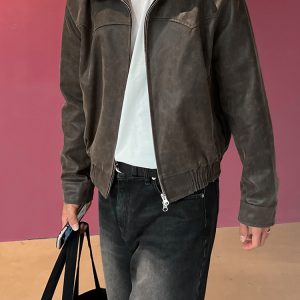 Mauroicardi leather bomber jacket with white t-shirt and black jeans, holding a black bag and smartphone, casual fashion style, urban streetwear, men's apparel, stylish outerwear, DeoVeritas brand imagery.