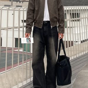 Mauroicardi casual streetwear outfit with leather jacket and bag, urban background, modern fashion style, black jeans, white sneakers, outdoor setting.