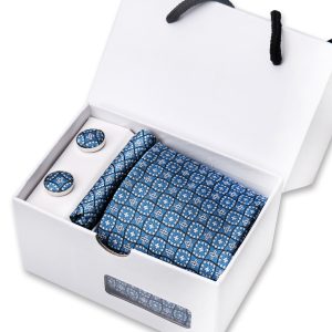 Polished blue patterned men's accessories set including a pocket square, tie, and cufflinks in a white gift box, perfect for formal or wedding attire.