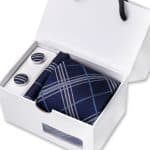 Elegant men's gift set featuring a stylish navy plaid necktie and matching cufflinks in a sleek white gift box for special occasions.