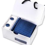 Elegant men's accessories set including a matching tie, pocket square, cufflinks, and lapel pin with a blue and yellow polka dot pattern, perfect for formal occasions.